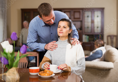 Portrait of happy couple drinking tea together at parents home