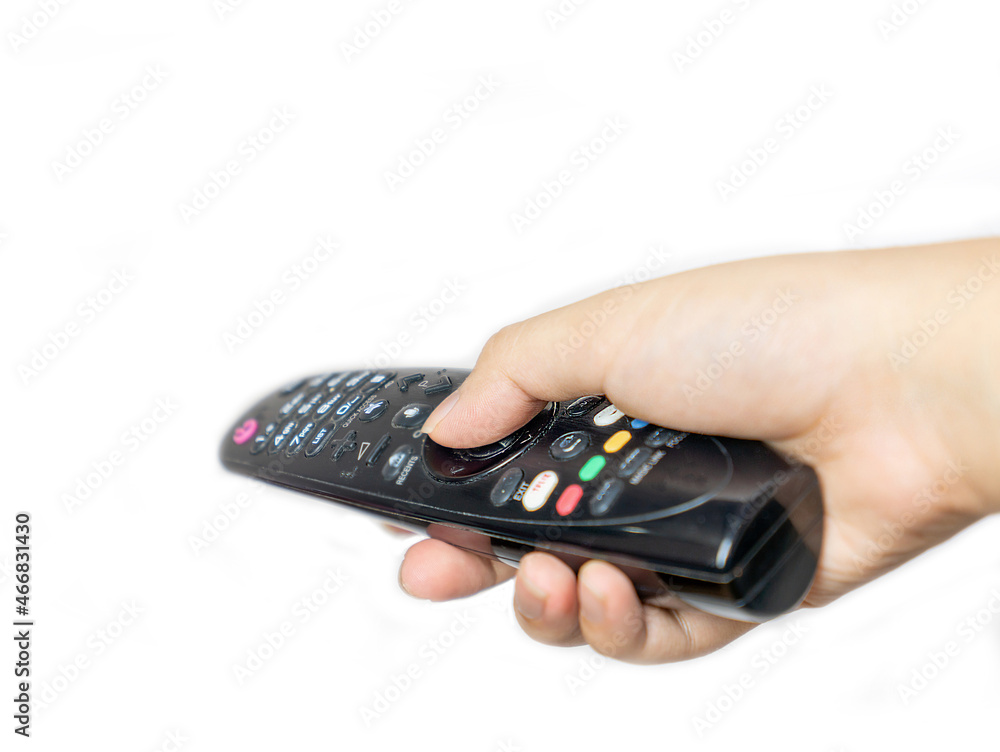 The man press button on television remote control. The man press button on television remote control.
