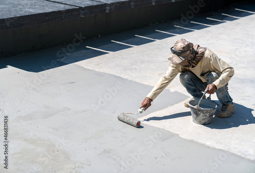 Construction worker paint water proof cement in pool.