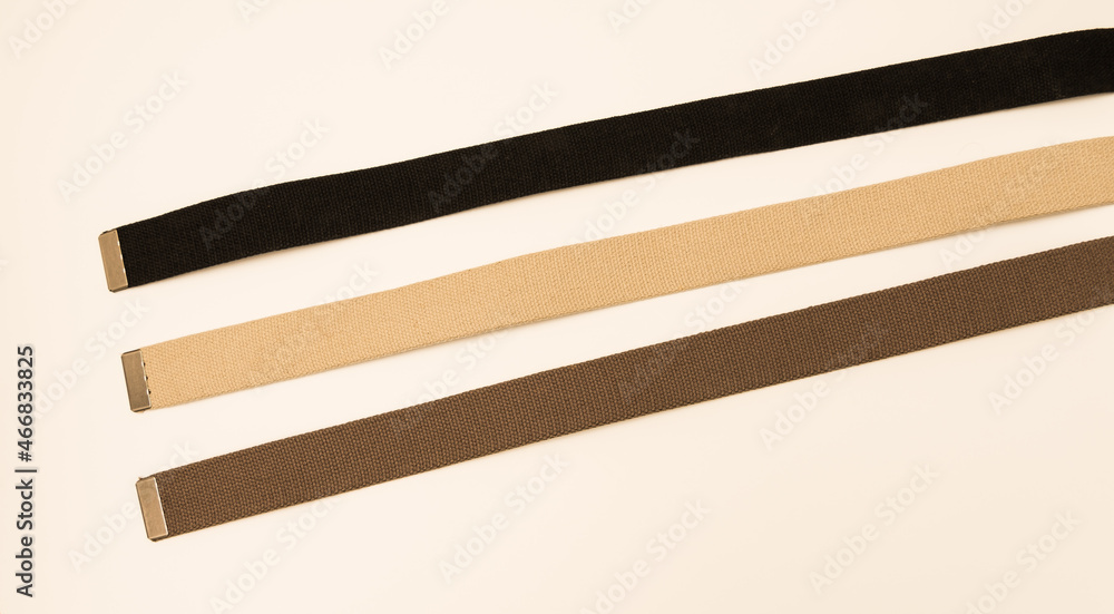 Three colorful canvas belts shot isolated against a white background. 