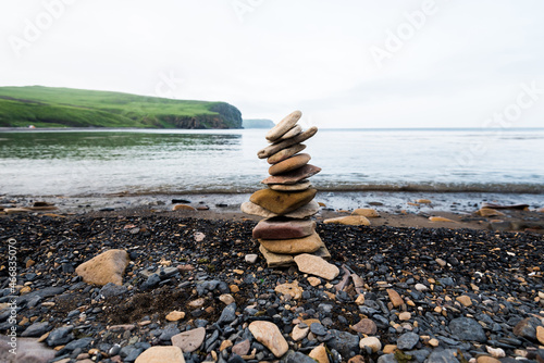 Stones pyramid on the seashore.