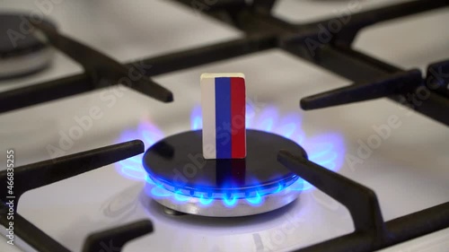 Shortage and gas crisis. Flag of the Russian on a burning gas stove