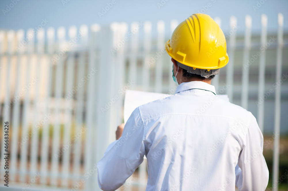 Engineer hold paper work or blueprint and survey on site construction Engineer hold paper work or blueprint and survey on site construction