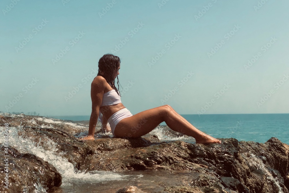 woman sitting on the rocks