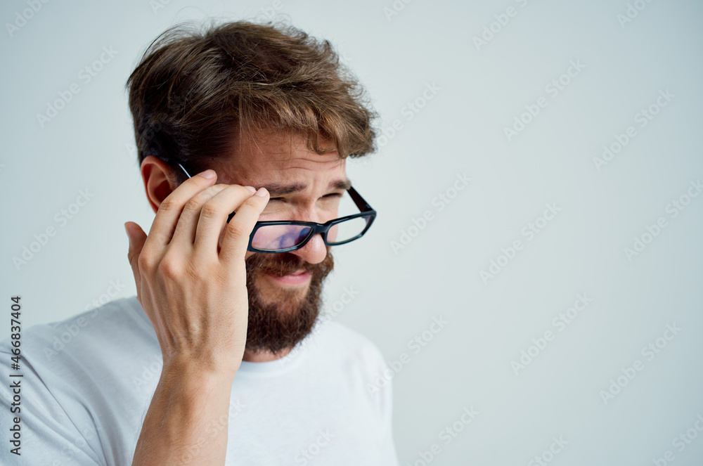 bearded man with poor eyesight health problems light background bearded man with poor eyesight health problems light background