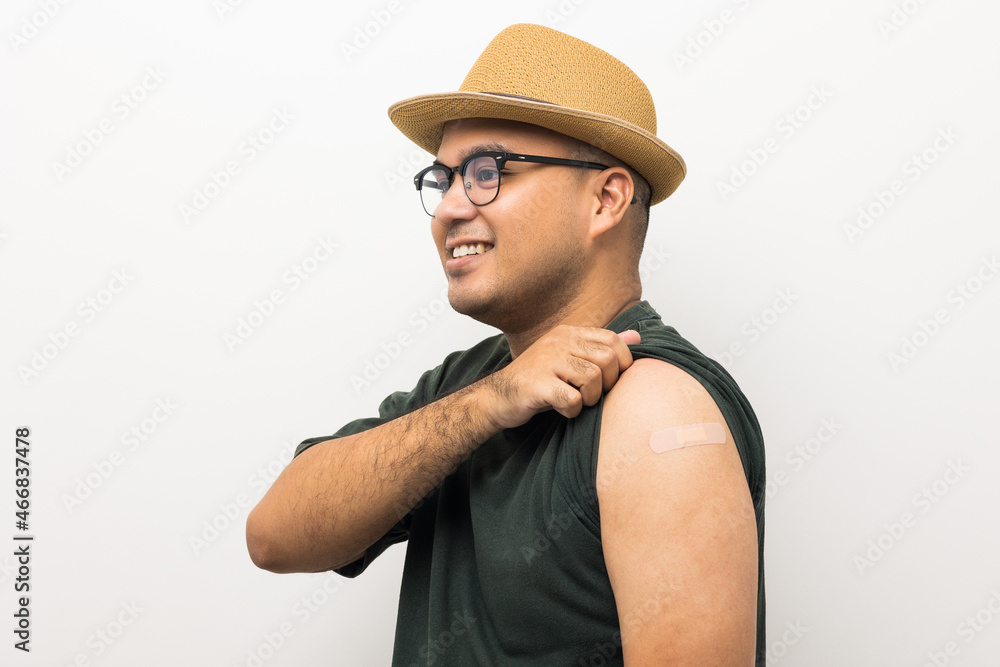Vaccinated asian man with hat showing arm after coronavirus Vaccination isolated white Background. Indian man getting a vaccination covid-19 immunization Vaccinated asian man with hat showing arm after coronavirus Vaccination isolated white Background. Indian man getting a vaccination covid-19 immunization