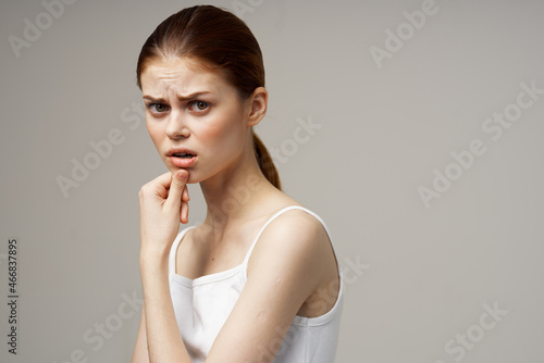 woman in white t-shirt toothache health problems disorder light background