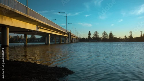 The afternoon sunshine is reflected onto The Entrance bridge at the Tuggerah Lakes inlet entrance. photo