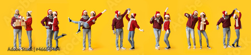 Set of young couple in stylish winter clothes and Santa hats on yellow background