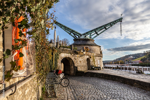 Sightseeing in Würzburg, germany: Historical old crane at the bank of the river Main photo