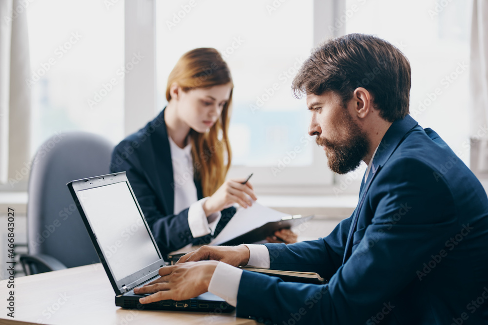 managers in the office in front of a laptop career network professionals managers in the office in front of a laptop career network professionals
