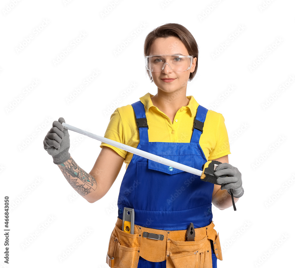 Female construction worker with measuring tape on white background