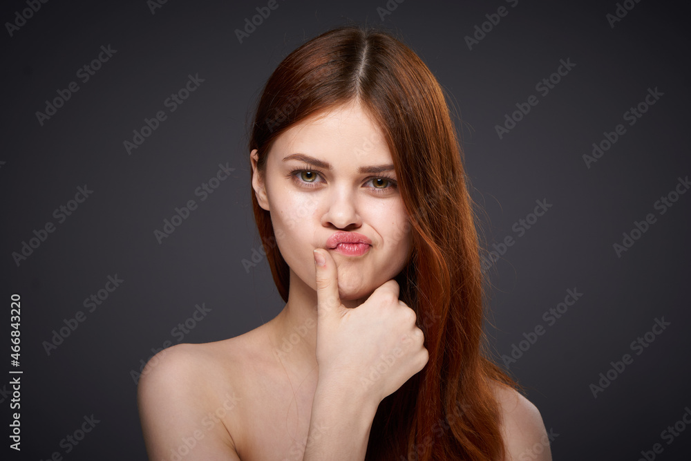 pretty red-haired woman naked shoulders posing dark background pretty red-haired woman naked shoulders posing dark background