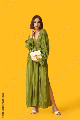 Fashionable young woman with stylish accessories on color background