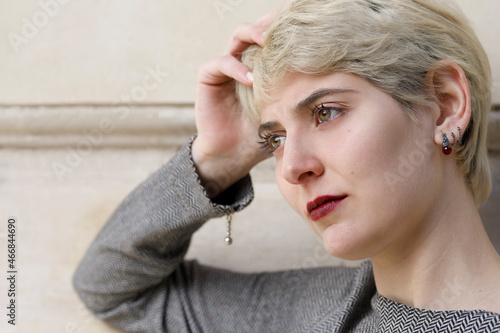 Portrait of young woman with serious expression of concern or thoughtfulness. She looks out of frame.