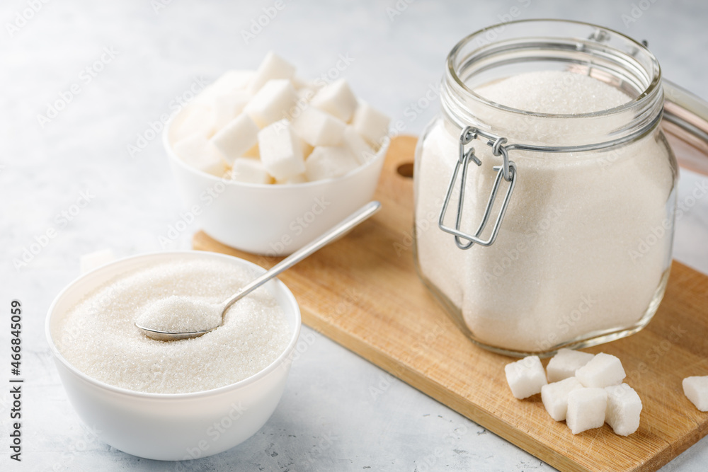 White granulated sugar and sugar cubes White granulated sugar and sugar cubes