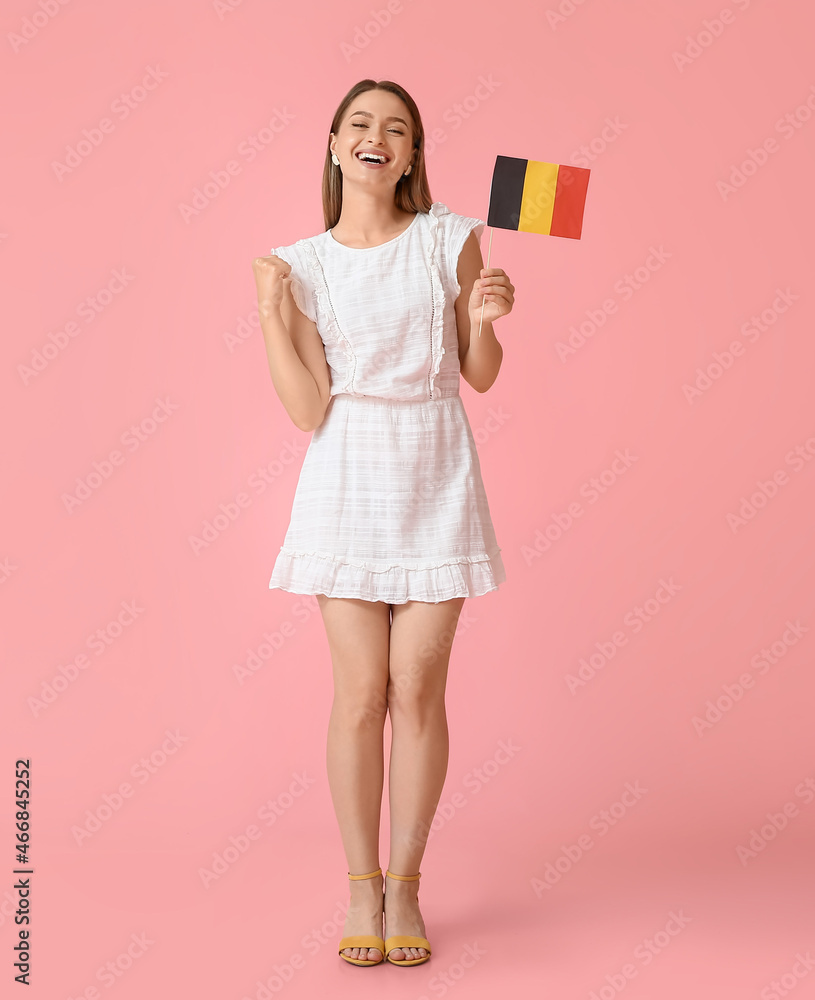 Happy young woman with flag of Belgium on color background Happy young woman with flag of Belgium on color background