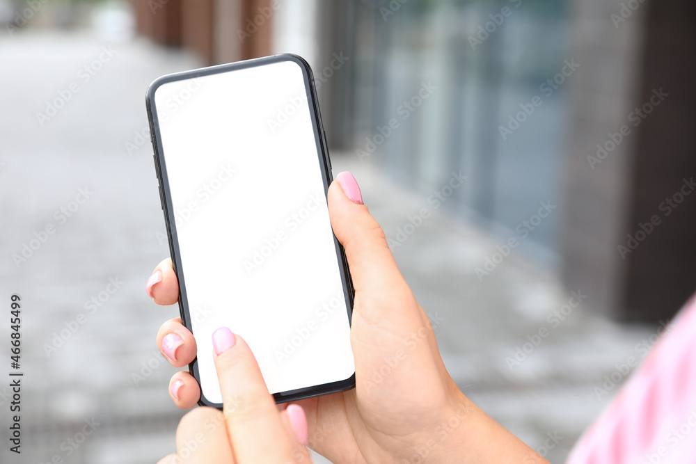 Woman using mobile phone near modern building, closeup Woman using mobile phone near modern building, closeup
