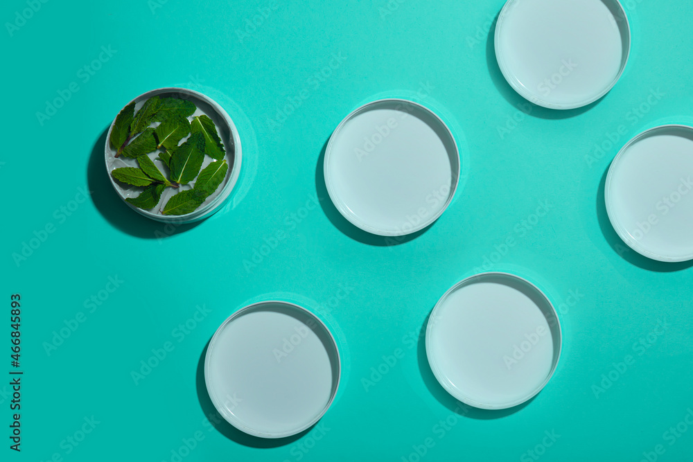 Pattern from cream with mint on a turquoise background, the concept of skin care and cosmetology. Pattern from cream with mint on a turquoise background, the concept of skin care and cosmetology.