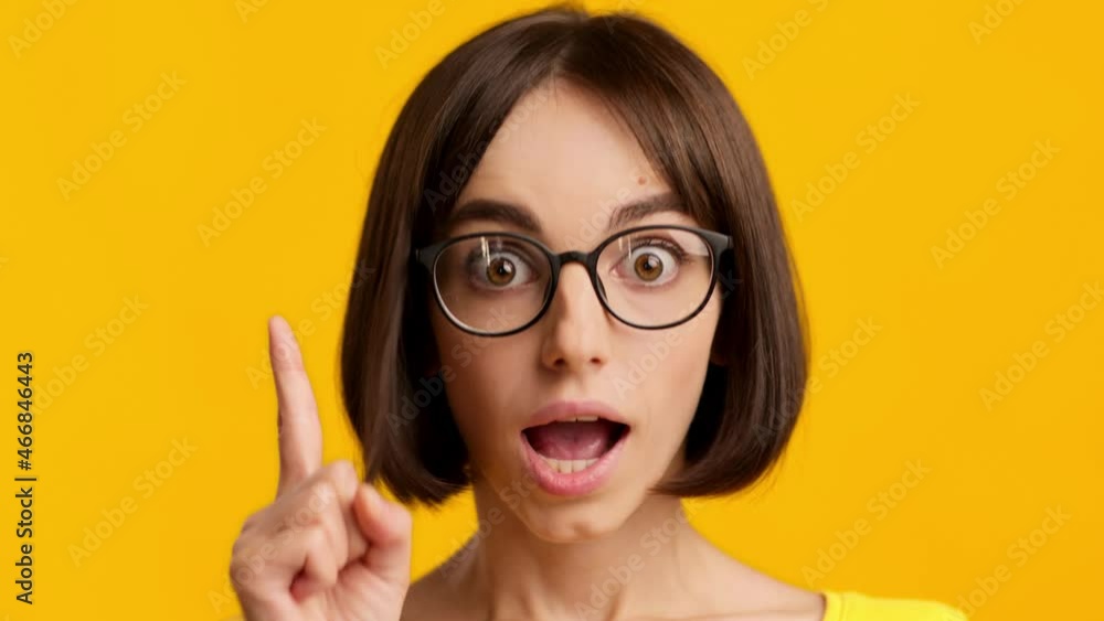Woman Thinking And Having Idea Pointing Finger Up, Yellow Background Woman Thinking And Having Idea Pointing Finger Up, Yellow Background