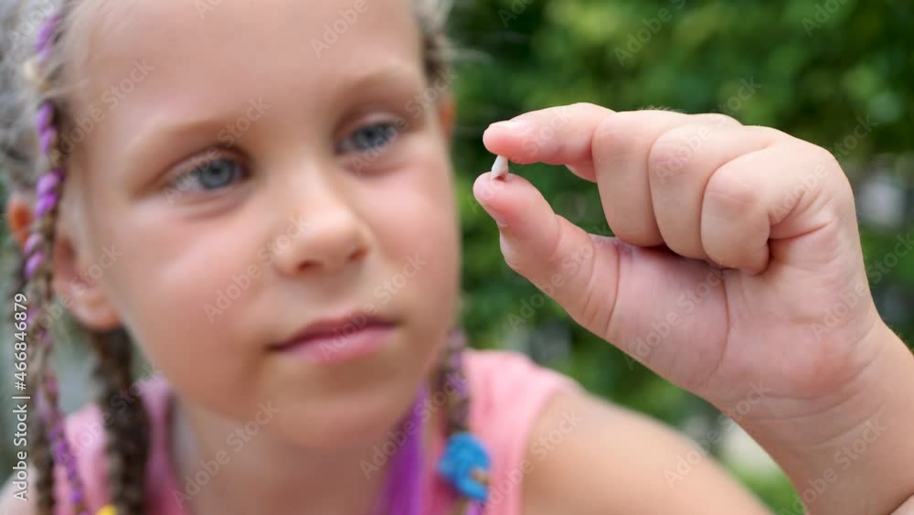 Little girl with milk temporary wobbly tooth. Dental medicine or temporary teeth healthcare concept. Tooth Fairy Little girl with milk temporary wobbly tooth. Dental medicine or temporary teeth healthcare concept. Tooth Fairy