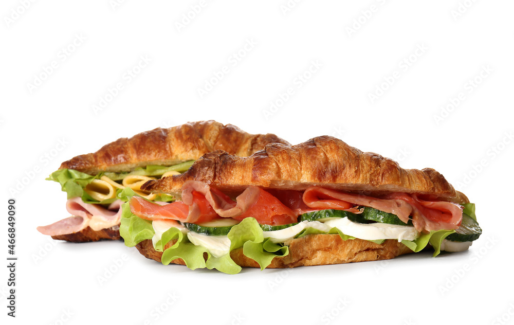 Delicious croissant sandwiches with fish on white background