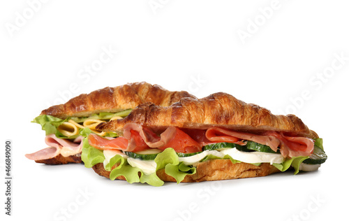 Delicious croissant sandwiches with fish on white background