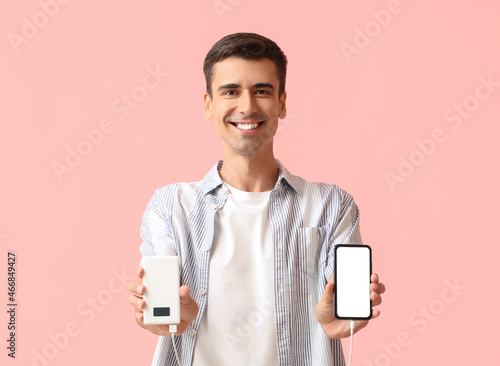 Young man with phone and po...
