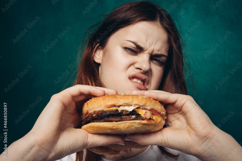 cheerful woman with hamburger near face snacking fast food cheerful woman with hamburger near face snacking fast food