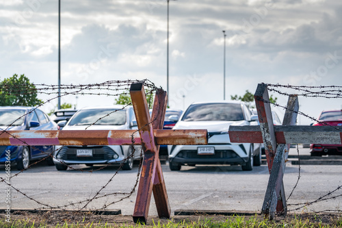 Barbed wire fence of the parking lot. Cars parked at outdoor car parking lot. Car was seized by a lending company. Financial crisis impact on car loan. Used car business. Auto leasing and insurance.