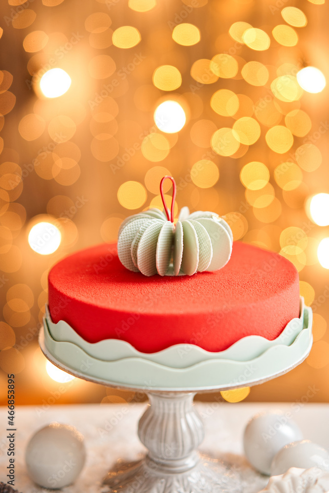 Mousse cake covered with red velour. Garland lamps bokeh on background.  Modern european cake. French cuisine. Christmas theme. Copy space Stock  Photo | Adobe Stock