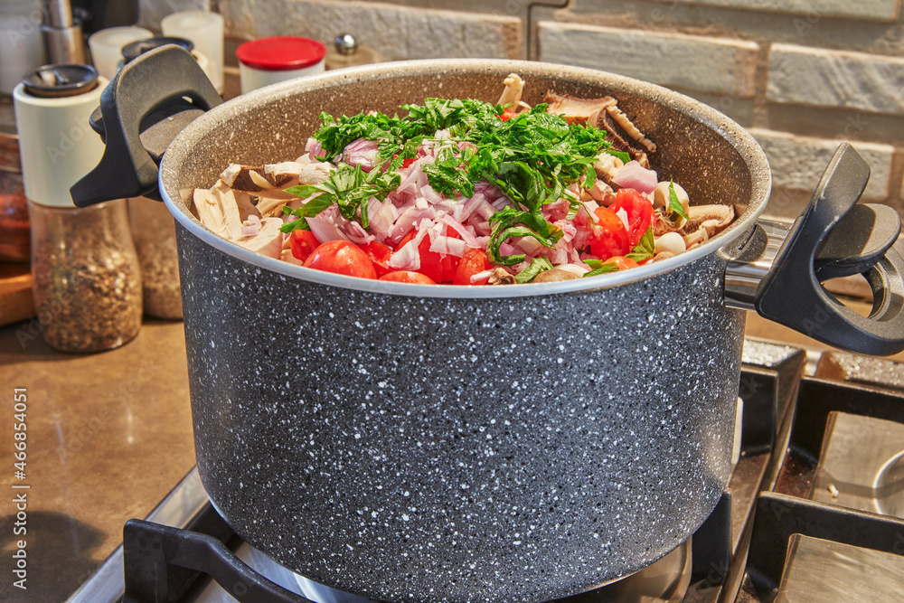 Saucepan on gas stove with vegetables for soup Saucepan on gas stove with vegetables for soup
