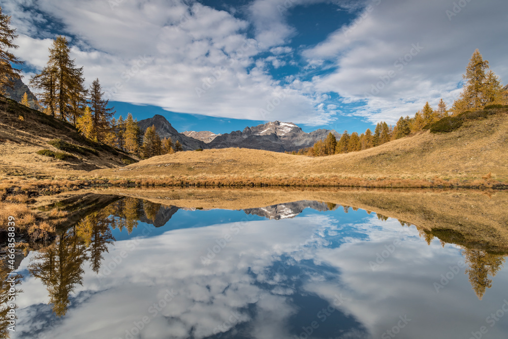 The Ofenhorn reflected in the lake, autumn in the wild Alps