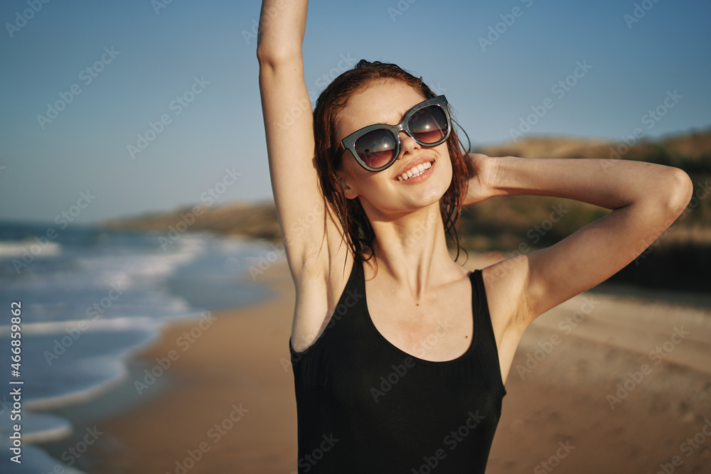 pretty woman in black swimsuit posing sun walking on the beach pretty woman in black swimsuit posing sun walking on the beach
