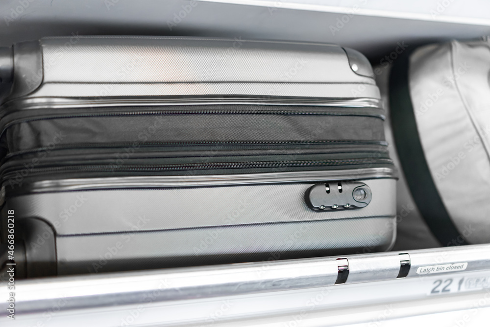 luggage on the top airplane shelf overhead passenger seat luggage on the top airplane shelf overhead passenger seat