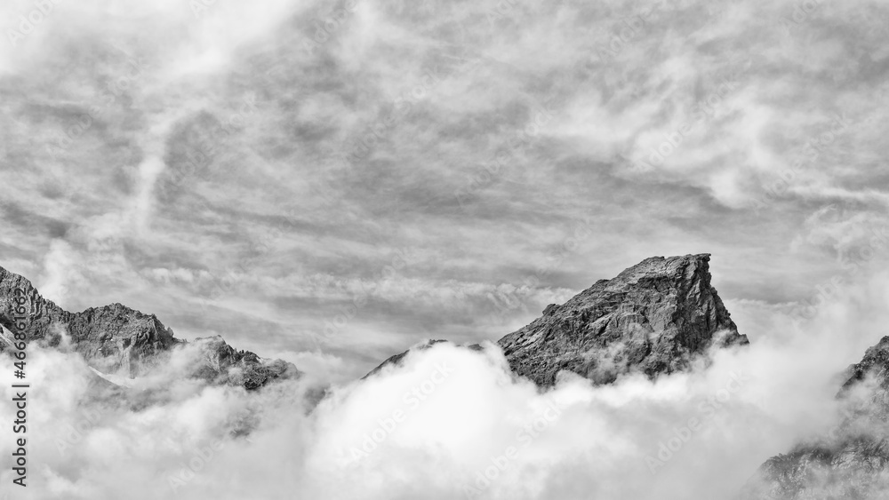 Beyond the clouds, black and white landscape in the Alps