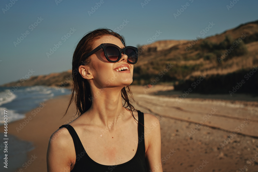 woman on the beach in sunglasses in a swimsuit sun woman on the beach in sunglasses in a swimsuit sun
