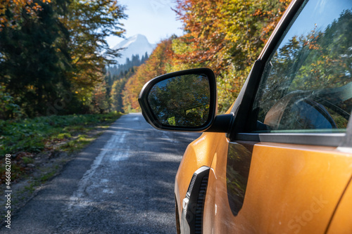 SUV driving beauty, asphalt mountain road in autumnal robe
