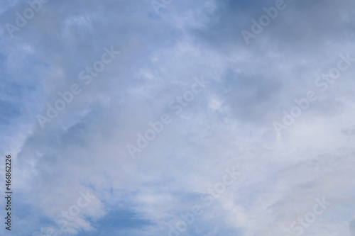 Abstract background of white fluffy clouds on a bright blue sky