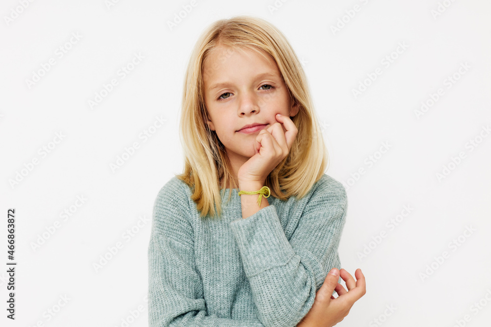 Beautiful little girl with blond hair on a light background Beautiful little girl with blond hair on a light background