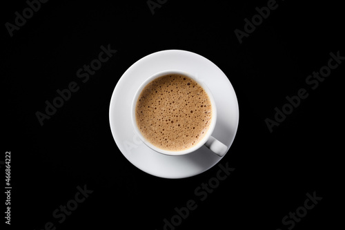 Cup of coffee on black background. Top view. Copy space.