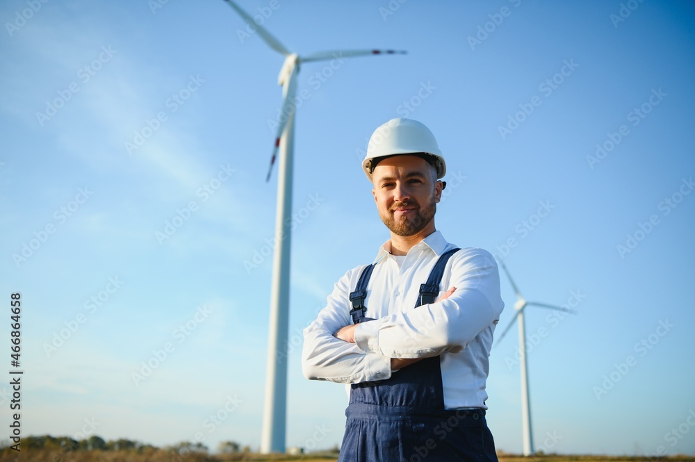 Engineer in wheat field checking on turbine production Engineer in wheat field checking on turbine production