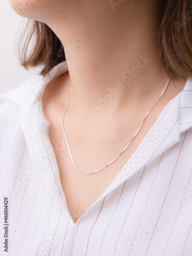 Silver necklace on a lady's neck.