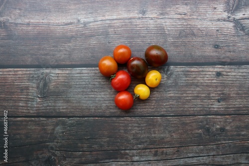 colorful tomatoes on wooden background
