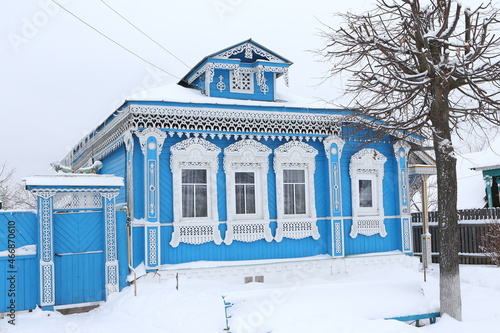 Vintage wooden rural house in Dunilovo village in Ivanovo region, Russia. Building facade; ornamental windows with carved frames. Russian traditional national folk style in architecture. Countryside photo