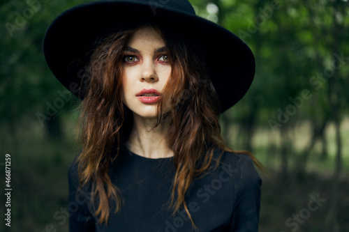woman dressed as a witch in the forest Halloween fantasy ritual