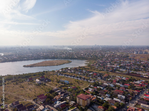 Aerial view of Pantelimon city , Dobroesti lake and Dobroesti island. Autumn 2021. Bucharest suburb. Romania

