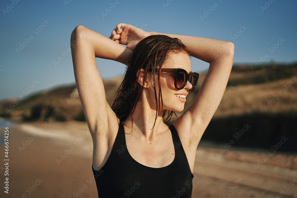 pretty woman in black swimsuit posing sun walking on the beach pretty woman in black swimsuit posing sun walking on the beach