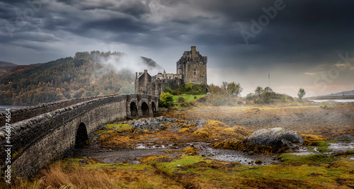 Panoramic view of the impressive Eilean Donan castle during a moody autumn day with fog and clouds, Scotland
