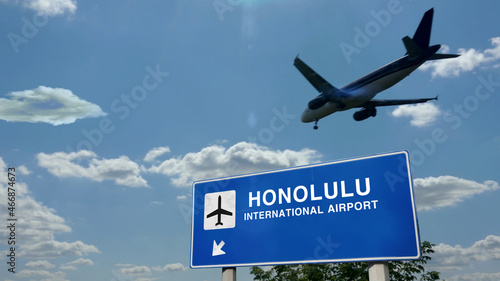 Plane landing in Honolulu Hawaii, USA airport with signboard photo